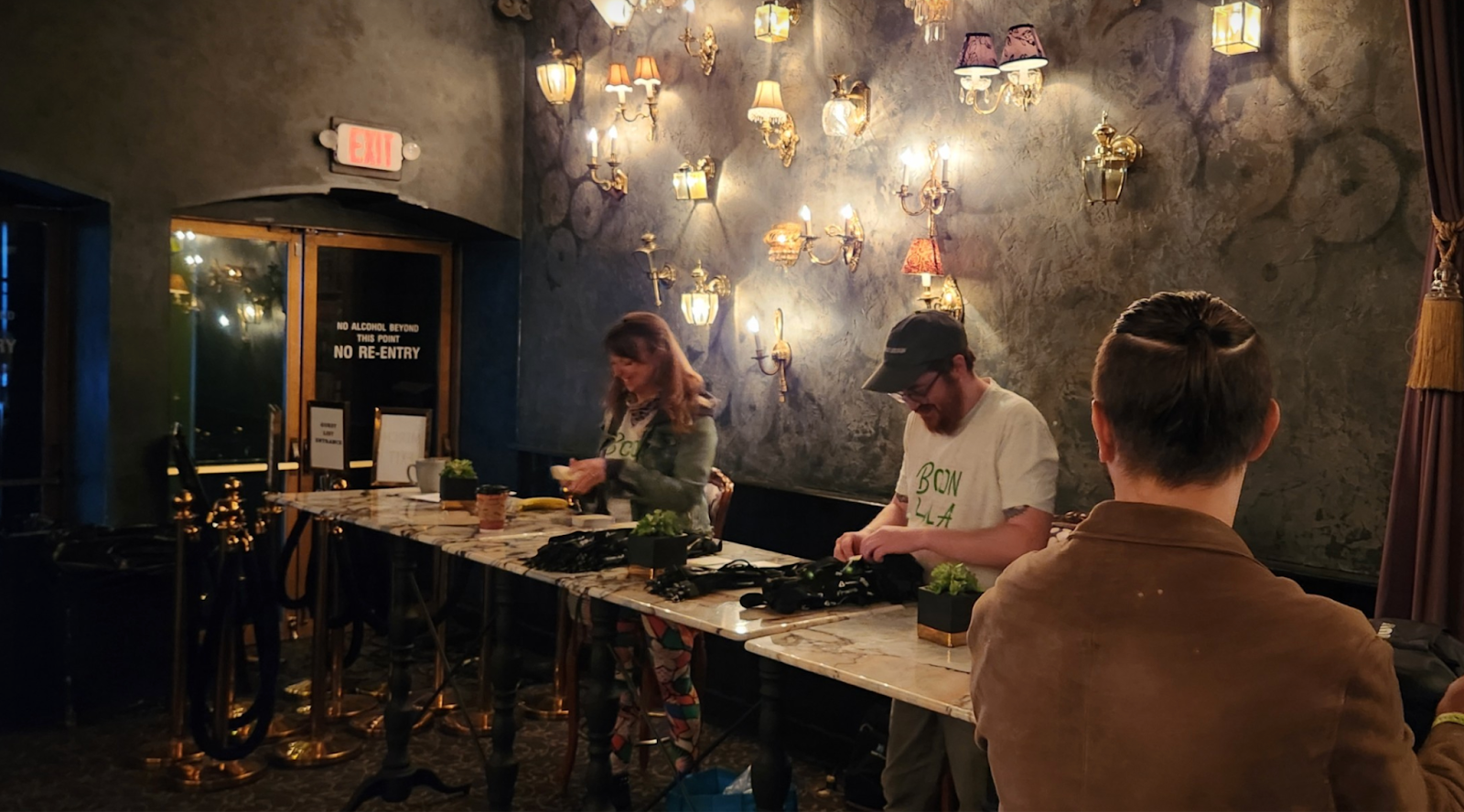 Amber, Kyle, and Jonathan Lampel preparing lanyards for the crowd